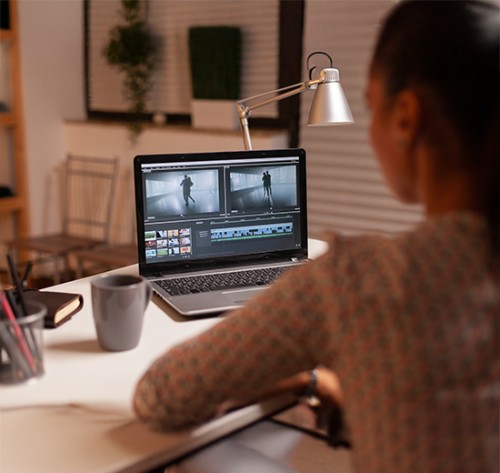 Woman editing video on laptop